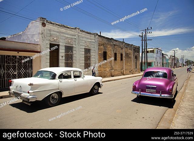 Old American cars in front of the colonial buildings at the historic center, Cienfuegos, Cienfuegos Province, Cuba, West Indies, Central America