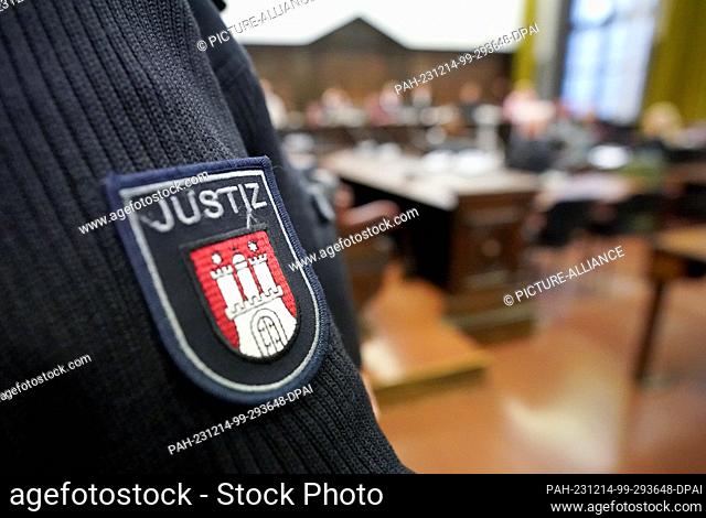 14 December 2023, Hamburg: A judicial officer stands in the courtroom in the criminal justice building at the start of the trial for attempted murder
