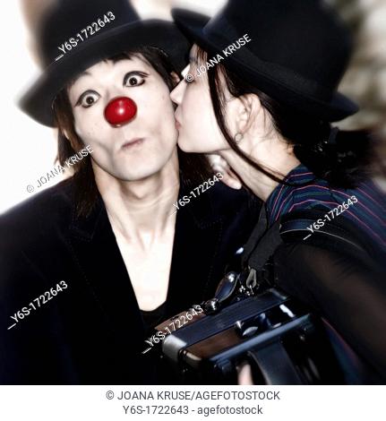 a couple of clowns - the woman kisses the man