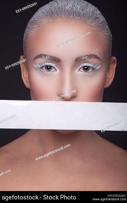 Beauty studio portrait of a beautiful girl with a white stripe around the mouth