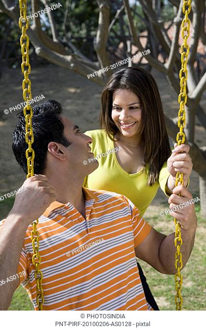 Couple on swing and smiling