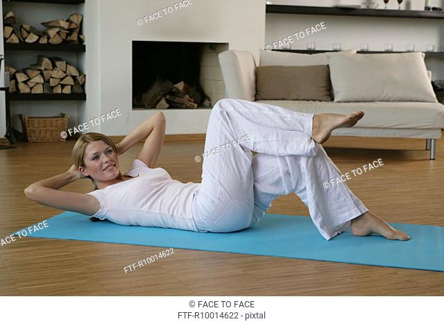 A woman lying on the floor and exercising
