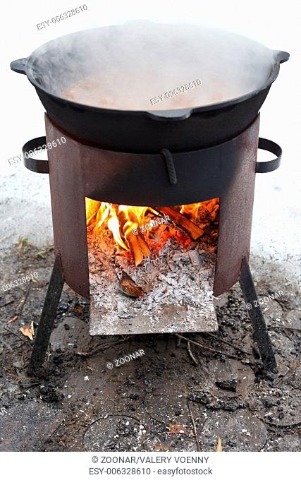 cooking stew on outdoor mobile brazier