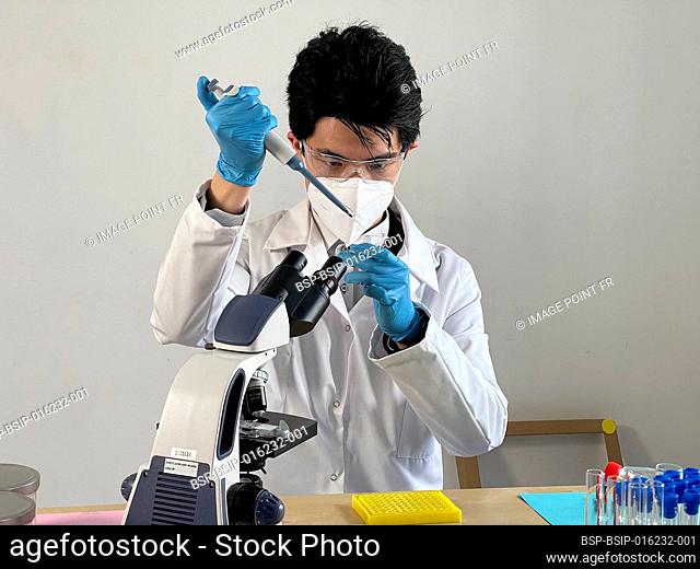 Laboratory technician carrying out experiments on different types of viruses and bacteria