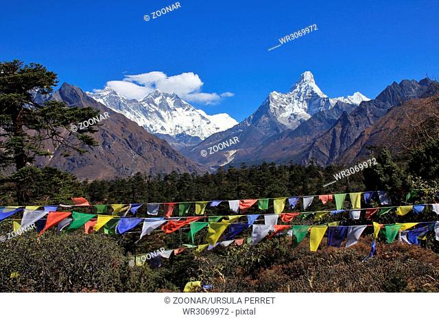 Prayer flags and snow capped mountains Lhotse and Ama Dablam