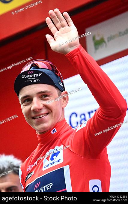 Belgian Remco Evenepoel of Quick-Step Alpha Vinyl celebrates on the podium in the red jersey for leader in the overall ranking after stage 10 of the 2022...