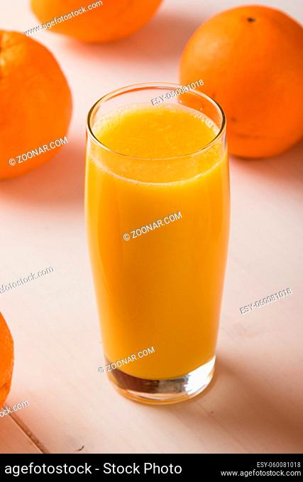 fresh orange juice with oranges on table
