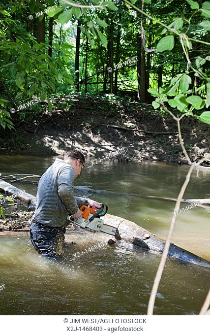 Southfield, Michigan - Volunteers clear a logjam from the Rouge River  They were part of the Rouge Rescue, an annual volunteer cleanup of the Rouge and...