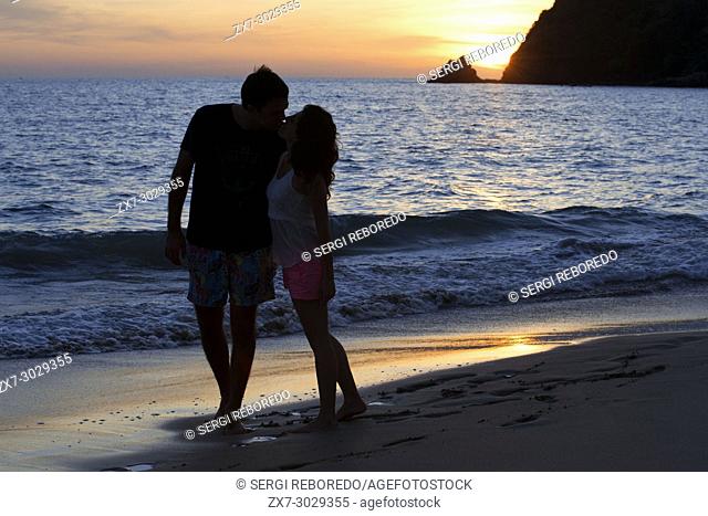 Couple lovers kissing at sunset in the beach. Kantiang Bay. Koh Lanta. Thailand. Asia. Kantiang Bay is most famous as the location of Pimalai