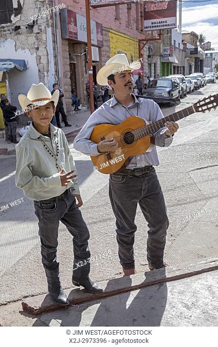 Nogales, Sonora Mexico - Street musicians play for pedestrians waiting in an hour-long line to cross the border into the United States