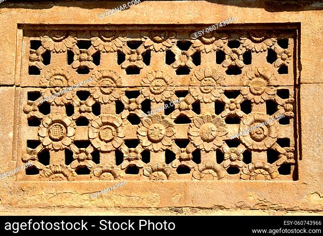 Artistically carved flower petals on stone window at Ladakhan Temple in Aihole, Bagalkot District, Karnataka, India, Asia