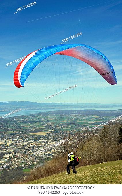 Paraglider taking off from Mont Saleve in France, tandem flight, panorama of Geneva in Switzerland below, Mont Saleve is located just next to Swiss-French...