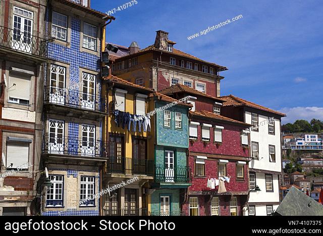 Colourful and run-down building exteriors in the Praça da Ribeira - Porto, Portugal