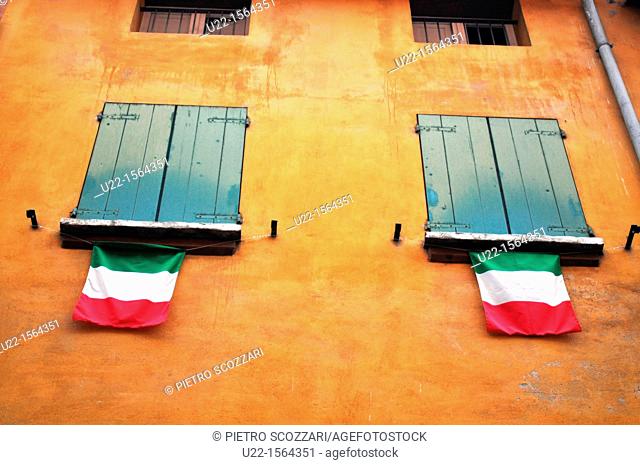 Bologna (Italy): Italian flags hanging by windows along via Santa Caterina, to commemorate the 150th year of the Republic