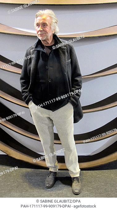 Picture of French sculptor Bernar Venet standing in front of the work ""Untitled"" by Robert Morris, taken during the ST-ART art fair in Strasbourg, France
