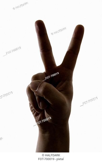A hand making a peace sign