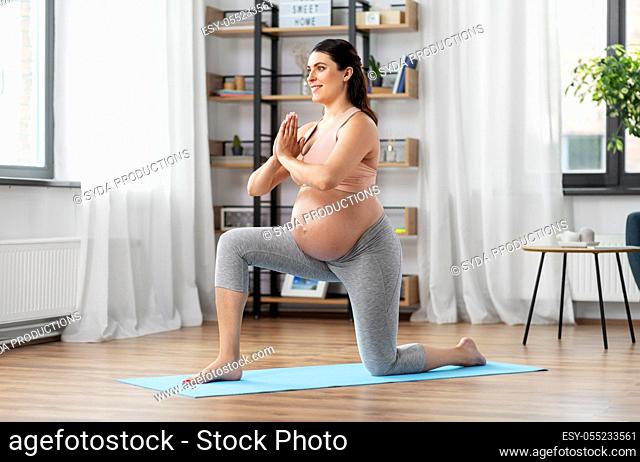 happy pregnant woman doing sports at home