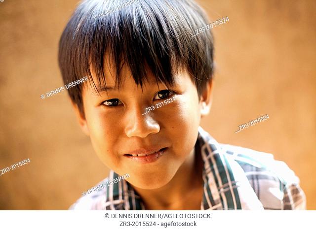 Portrait of a young Cambodian boy in a village outside of Phnom Penh, Cambodia