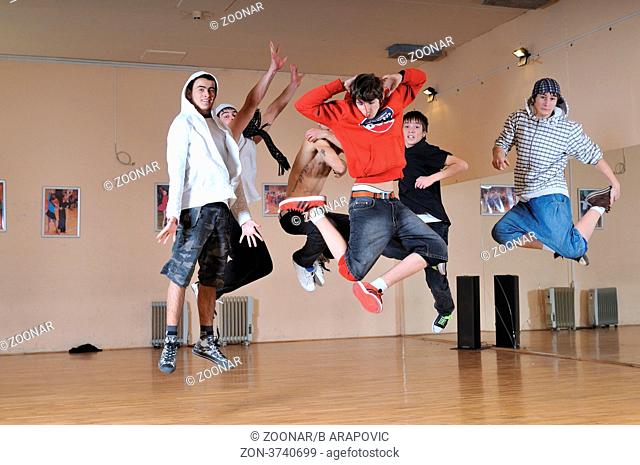 group of young teens jump in air together
