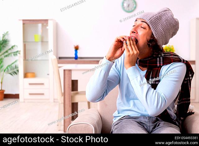 Young man suffering from flu at the home