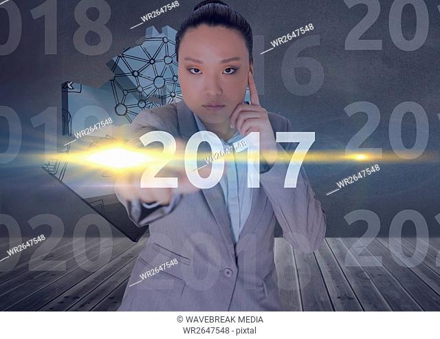 Business woman in 3D digitally generated background touching 2017