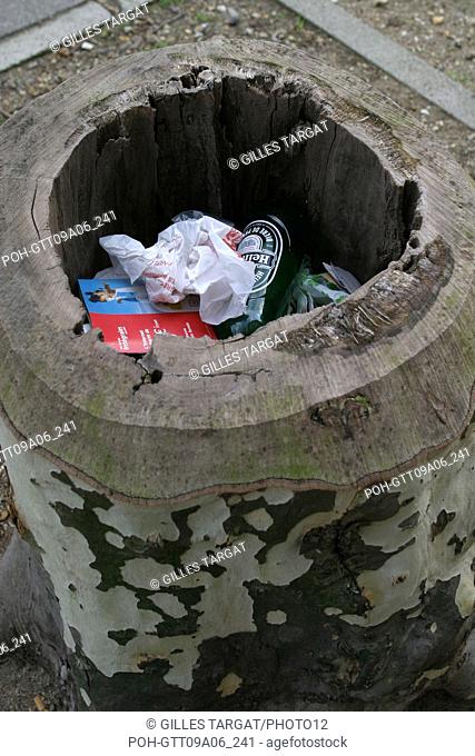 tourism, France, 1st arrondissement of paris, tree in city, trunk of sycamore serving as trash, pollution, trash, rubbish, dirty Photo Gilles Targat