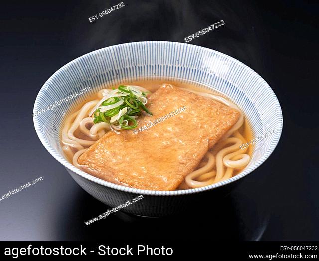 Udon noodles in a hot soup with deep fried tofu