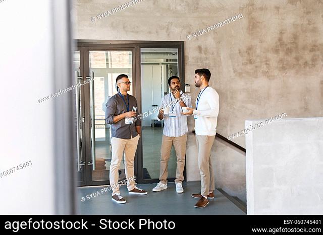 businessmen drinking coffee and water at office