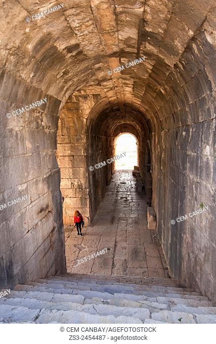 Tourist inside the ruins on a passageway leading to the ancient amphitheater of Miletus, Milet, Aydin Province, Turkey, Europe