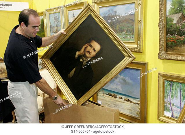 Convention Center, Antique Show, male exhibitor, painting, Edgar Allen Poe, portrait, framed. Miami Beach. Florida. USA