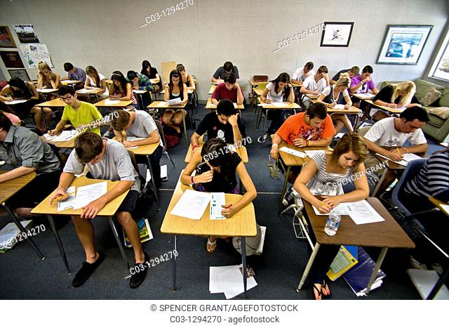 A multiracial Southern California high school class takes a multiple choice test, marking the answers on a Scantron card with a pencil to allow electronic...