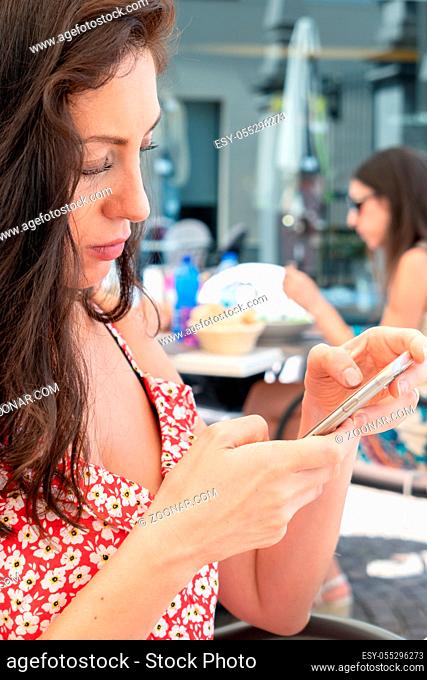 Attractive young woman using mobile phone. Leisure, technology, Social Network, communication and people concept