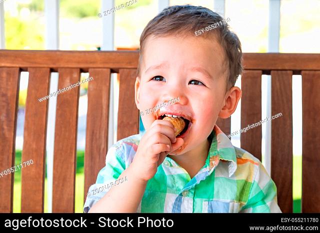 Young Mixed Race Chinese and Caucasian Boy Enjoying His Ice Cream Cone