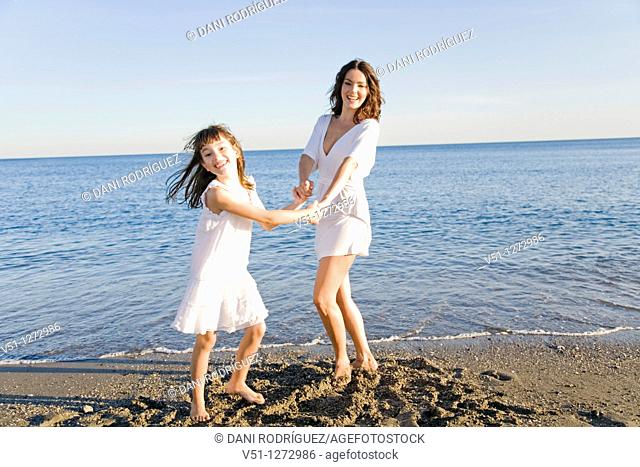 Mother and daughter having fun at the beach