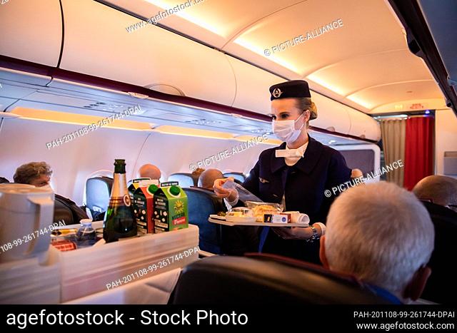 08 November 2020, Berlin: A flight attendant serves food and beverages on the last scheduled flight of the French airline Air France