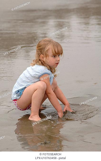 3 Year old playing in water on beach