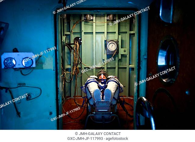 NASA astronaut Doug Hurley, STS-135 pilot, waits in a pressure chamber before a test of his Russian Sokol spacesuit at the Zvezda facility in Moscow on March 30