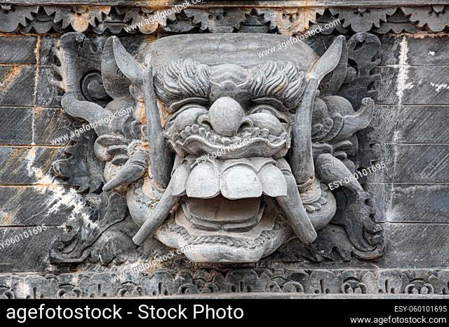 Stone face sculpture close-up in wall at Bali Indonesia