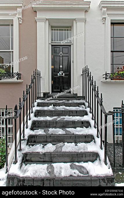 Snow at Stairs in Front of Black Door in London
