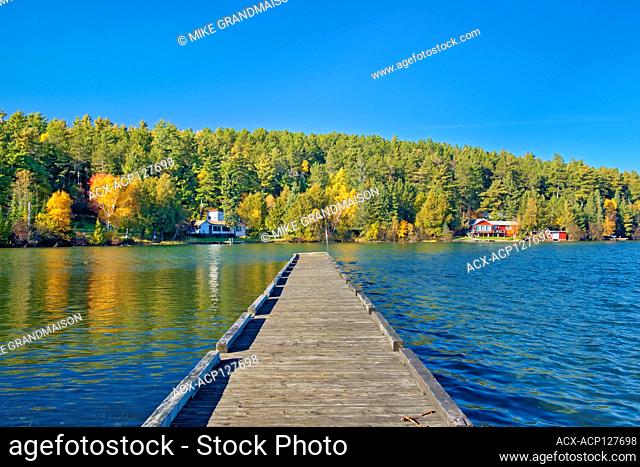 Dock and cottages and Autumn on Crow Lake (also known as Kakagi Lake). Near Sioux Narrows Ontario Canada