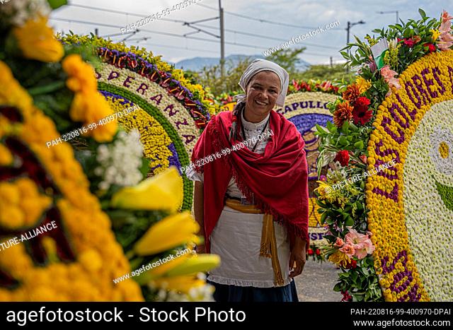 15 August 2022, Colombia, Santa Elena Antioquia: A Silletera woman in traditional costume waits before the Silletero parade as part of the Medellin Flower...
