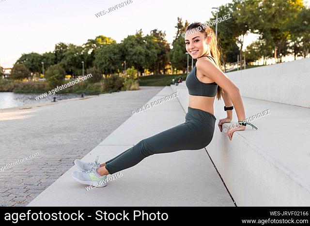Beautiful sportswoman exercising on steps
