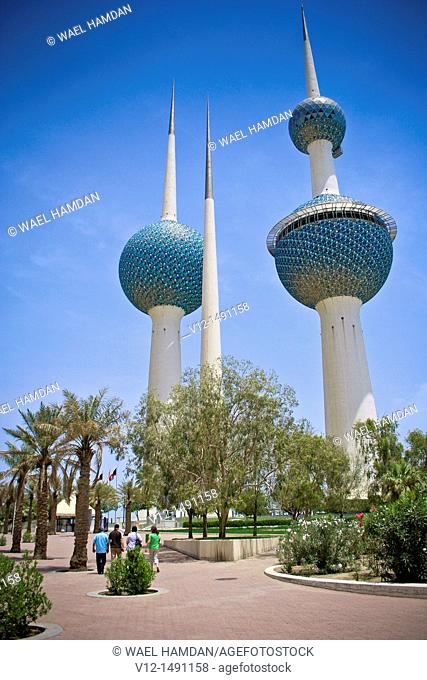 travelers walking by The Kuwait Towers, Kuwait city