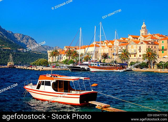Motorboat anchored near Korcula old town, Croatia. Korcula is a historic fortified town on the protected east coast of the island of Korcula