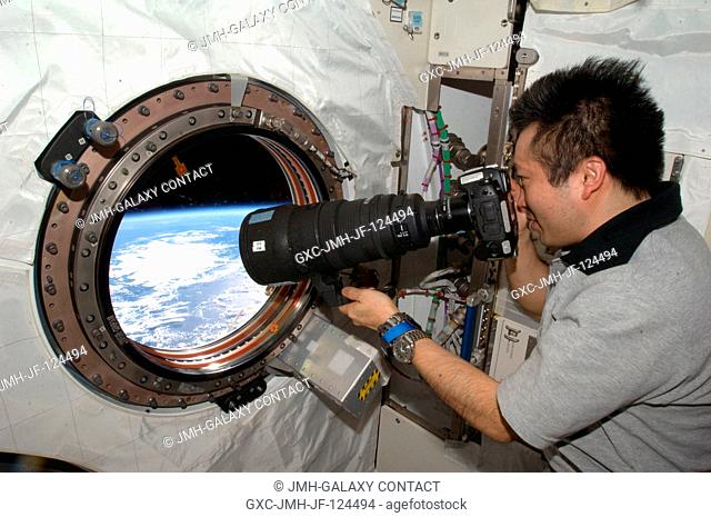 Japanese Aerospace Exploration Agency (JAXA) astronaut Koichi Wakata, Expedition 1920 flight engineer, takes pictures out the forward Kibo or JEM window on the...