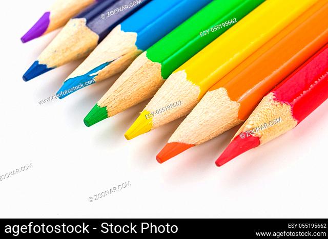 Many different colored pencils on white background