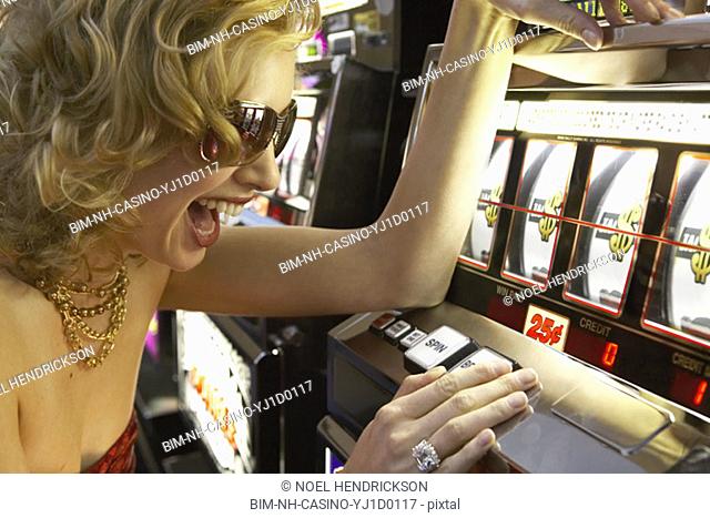 Young woman winning at the slot machine