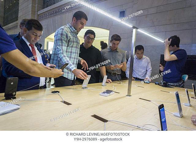 Customers in the Apple store in Grand Central Terminal in New York try out the new iPhone 8 and iPhone 8 Plus on Friday, September 22, 2017