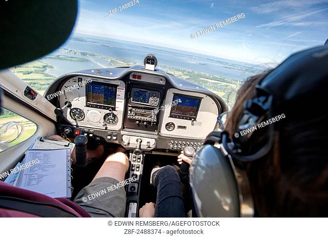 Father and daughter flying light plane over the eastern shore of Maryland, USA
