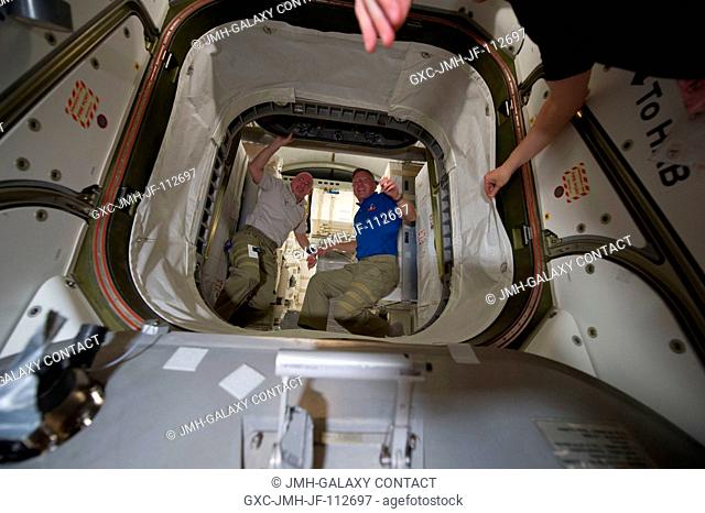 NASA astronauts Scott Kelly (left), Expedition 26 commander; and Steve Lindsey, STS-133 commander, are pictured in the hatch that leads to the newly-installed...
